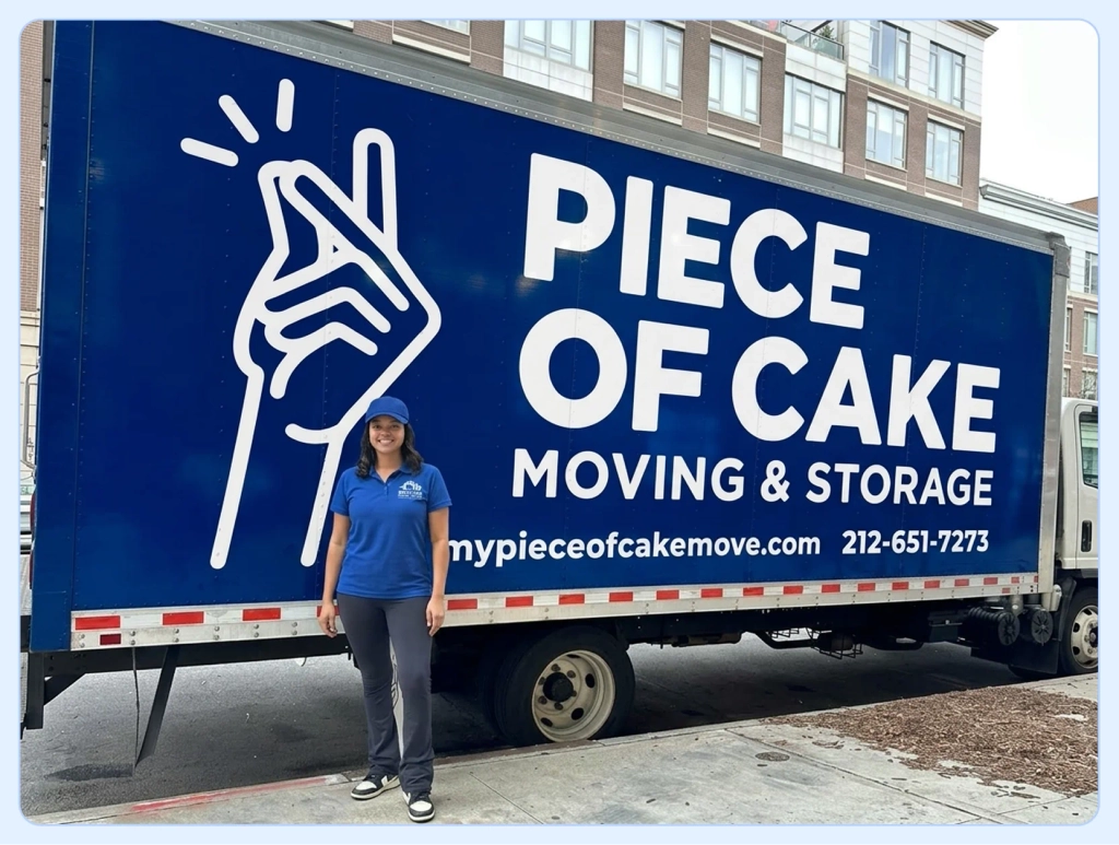 Mover in uniform beside a box truck branded with name, site and phone